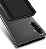 A close-up, angled view of a black flip case for a smartphone, showing the camera module on the back of the phone. Produktbild-Vorschau