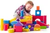 A young child is playing with colorful foam blocks. Voir les images du produit
