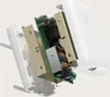 A disassembled view of a white Belkin wall charger, showing its internal electronic components. Voir les images du produit