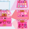 A collage of images showing a pink makeup case for children, with various compartments filled with makeup items like eyeshadow, blush, and nail polish. Produktbild-Vorschau