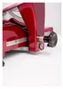 A close-up view of the side of a red meat slicer. Produktbild-Vorschau