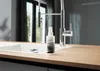 A bottle of cleaning product sits on a kitchen counter next to a sink and faucet. Produktbild-Vorschau