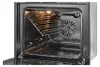 An open oven interior with a rack inside. Produktbild-Vorschau