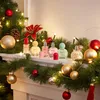 Perfume bottles arranged on a mantelpiece decorated with Christmas garland and lights. Náhled obrázku produktu