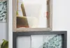 A close-up view of two stacked picture frames, one with a wooden frame and the other with a dark gray frame, displaying various images. Náhled obrázku produktu