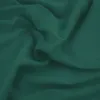 A close-up view of draped teal fabric.
