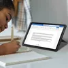 A young person is using a tablet and writing in a notebook. Produktbild-Vorschau