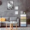 A living room scene with a sofa, coffee table, and a multi-colored drawer unit. Anteprima dell’immagine prodotto