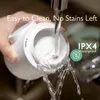 A hand is holding a white bottle warmer under a running faucet, with water pouring into it. Text overlays highlight its cleaning features and waterproof rating. Náhľad obrázku produktu