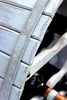 A close-up view of a white wooden wine rack with bottles of wine inside. Produktbild-Vorschau