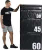 A man is standing next to a stack of black plyometric boxes. Produktbild-Vorschau