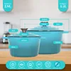 Two blue-green cast iron pots with measurement labels and icons indicating product features. Produktbild-Vorschau