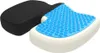 A close-up, studio shot of a U-shaped seat cushion with a black fabric cover and a blue gel layer with raised bumps. Náhľad obrázku produktu