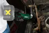 A person is using a cordless angle impact wrench to work on a car. Náhled obrázku produktu