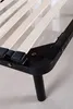 A close-up view of a bed frame's corner and wooden slats. Produktbild-Vorschau