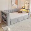 A modern daybed with integrated storage and lighting, set up in a bedroom. Voir les images du produit
