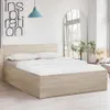 A bedroom scene with a bed, pillows, and a headboard. Podgląd zdjęcia produktu