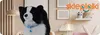 A plush dog toy sits in a child's room setting with decorative items on the wall. Anteprima dell’immagine prodotto