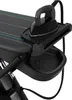 Close-up of a black ironing board with an iron resting on it, showing a storage tray and a power cord. Produktbild-Vorschau