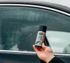 A hand holding a spray can of K2 FOX Anti-Fog spray in front of a car window. Podgląd zdjęcia produktu