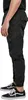 A person wearing black cargo pants and black Vans sneakers, shown from the waist down. Produktbild-Vorschau