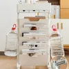 A white mobile storage cart filled with magazines and books, with two large water bottles hanging from the sides. Produktbild-Vorschau
