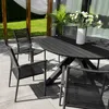An outdoor dining set on a patio with a lawn and pergola in the background. Produktbild-Vorschau