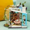 A miniature dollhouse with a spiral staircase, balcony, and interior rooms. Anteprima dell’immagine prodotto
