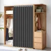 A wardrobe with clothes and accessories, featuring a dark gray curtain. Náhled obrázku produktu