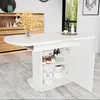 A white oval dining table with storage is shown in a room with a wooden cabinet and a window. Voir les images du produit