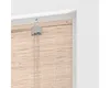 A close-up view of the top mechanism and a portion of a bamboo roller blind. Náhled obrázku produktu