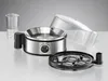 The image shows various parts of an egg cooker arranged on a reflective surface against a gray background. Produktbild-Vorschau