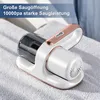 A handheld vacuum cleaner is placed on a white textured surface, possibly a towel or fabric. Produktbild-Vorschau