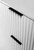 A close-up shot of a white cabinet with ribbed drawers and black handles. Produktbild-Vorschau