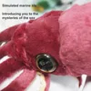 Close-up of a plush squid toy with text overlays. Podgląd zdjęcia produktu