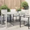 A white rattan dining set with a glass top table and four chairs is set up on a patio. Produktbild-Vorschau
