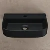 A black ceramic sink is shown against a textured brown and gray background. Produktbild-Vorschau