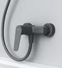A close-up view of a modern dark gray shower faucet mounted on a light gray wall. Produktbild-Vorschau