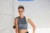 A woman is leaning against a white wall with a Blackroll Mini Flow fascia roller on her back. Anteprima dell’immagine prodotto