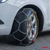 A close-up of a car tire with snow chains installed. Produktbild-Vorschau