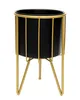 A black planter pot with a gold metal stand. Podgląd zdjęcia produktu