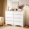 A white dresser with multiple drawers is placed in a room with a couch and curtains. Decorative items like a lamp, books, a radio, and framed pictures are on top of the dresser. Podgląd zdjęcia produktu