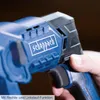 A close-up shot of a blue and black power tool, held by a person's hand. Produktbild-Vorschau