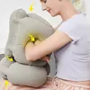 A woman is using an inflatable travel pillow. Produktbild-Vorschau