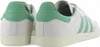 A pair of white and green Adidas Samba sneakers shown from a rear-side angle. Produktbild-Vorschau