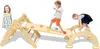 Three children are playing on a wooden climbing structure indoors. Voir les images du produit