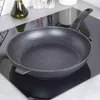A frying pan sits on a black induction stovetop. Anteprima dell’immagine prodotto