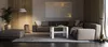 A modern living room with a sectional sofa, coffee table, ottoman, and plant. Náhled obrázku produktu