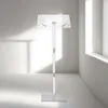 A white podium stand in a minimalist room with natural light. Náhľad obrázku produktu