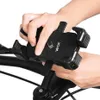 Hands adjusting a black phone holder on a bicycle handlebar. Anteprima dell’immagine prodotto
